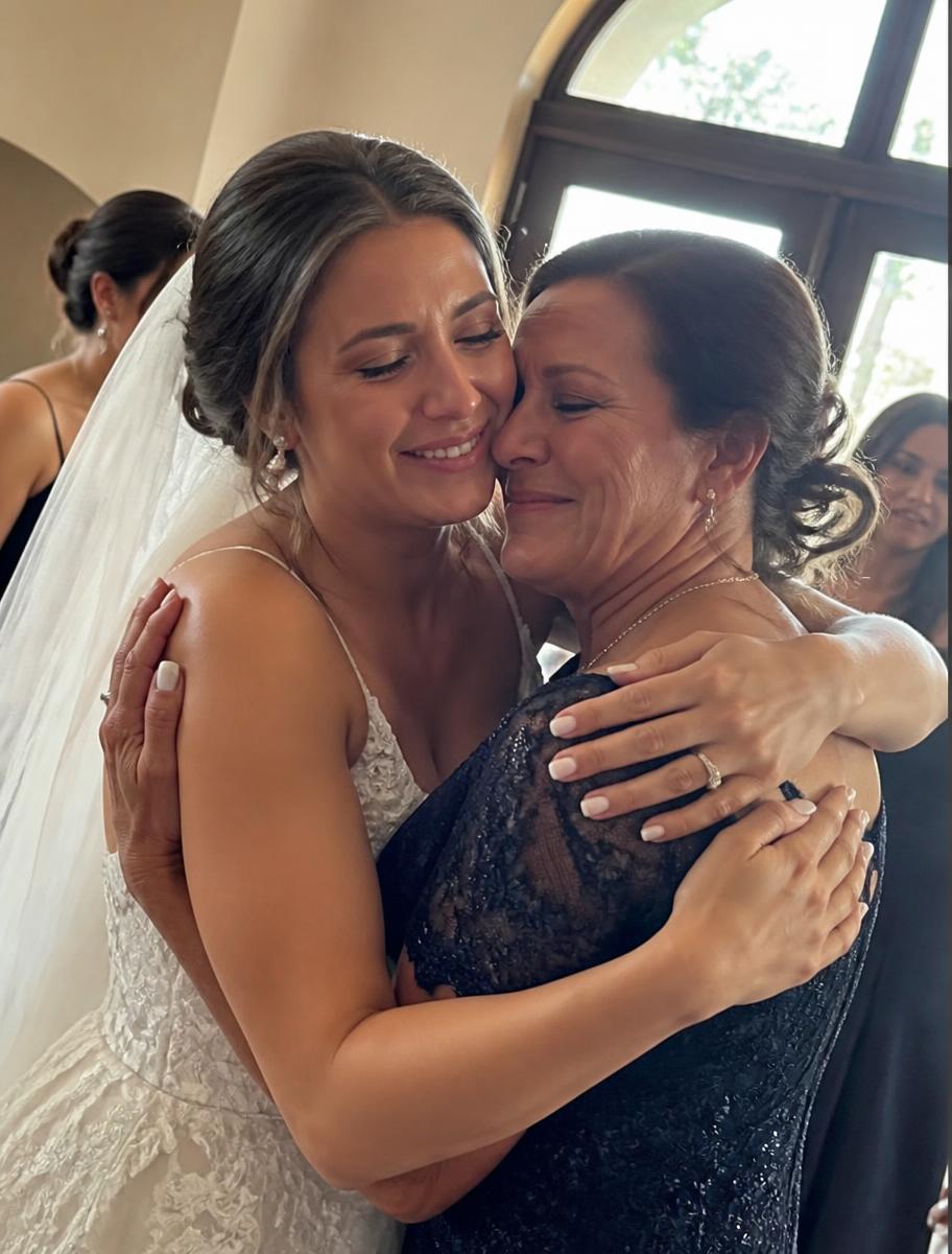 The bride embracing her mother