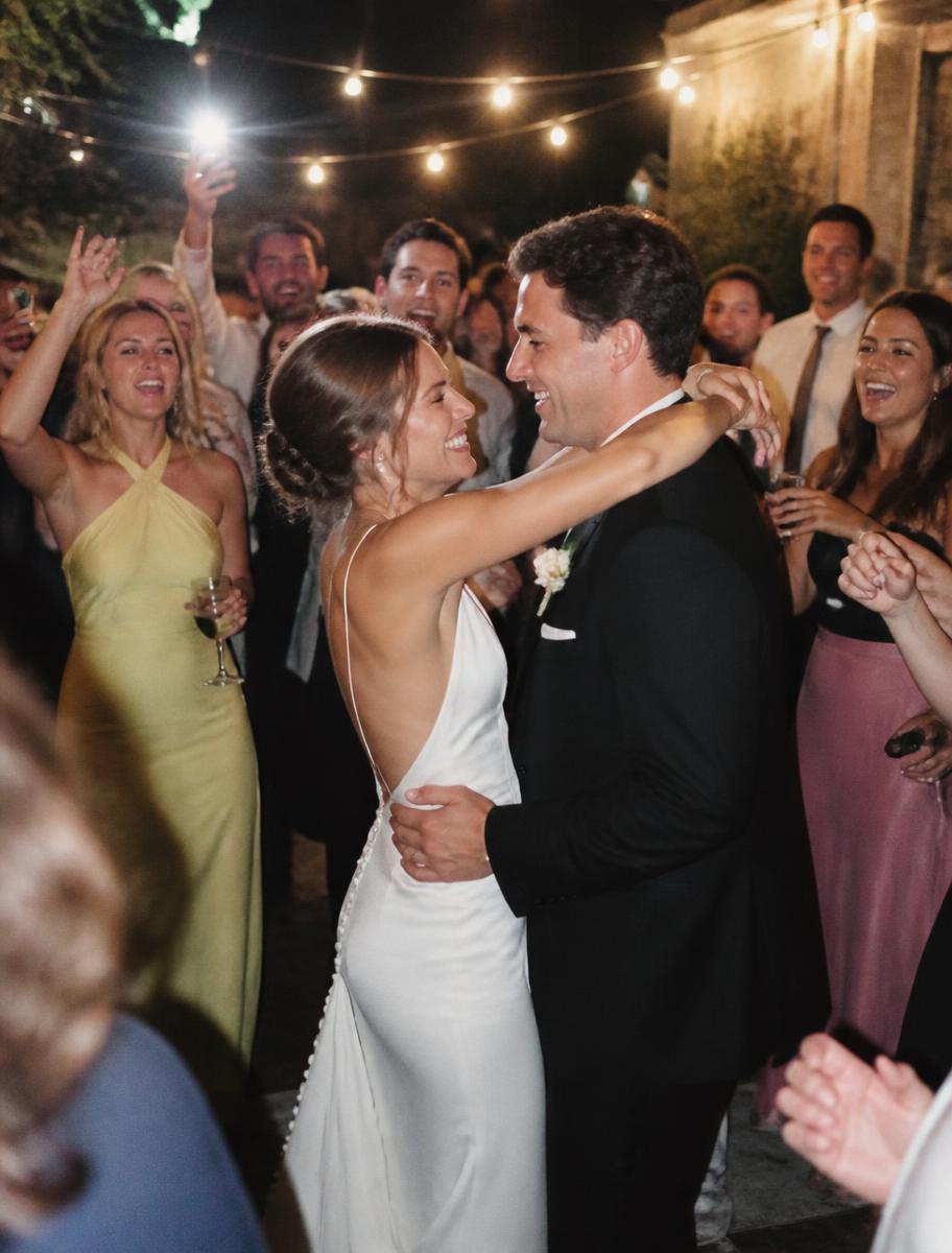 The couple dancing surrounded by friends